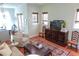 Cozy living room featuring hardwood floors, area rug, and comfortable seating next to open kitchen at 7 Fields Pl, Charleston, SC 29403