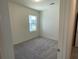 Neutral bedroom with carpet, a window bringing in natural light, and a view into the hall at 719 Pisces Ln, Summerville, SC 29486