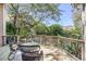 Back deck featuring wood flooring, a metal railing, and serene views of the lush backyard at 772 Preservation Pl, Mount Pleasant, SC 29464