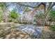 Well-maintained backyard with green lawn, mature trees, a paved patio, and an elevated back deck at 772 Preservation Pl, Mount Pleasant, SC 29464