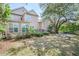 Exterior view of house with back deck, lush landscaping, and a spacious lawn with lovely plantings at 772 Preservation Pl, Mount Pleasant, SC 29464
