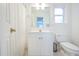 Well-lit bathroom with a white vanity, mirror, toilet, and shower with white curtain at 772 Preservation Pl, Mount Pleasant, SC 29464