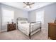 Bright bedroom featuring a metal bed frame, bedside table, and windows for ample natural light at 772 Preservation Pl, Mount Pleasant, SC 29464