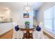 Elegant dining area with a glass-top table, decorative chandelier, and hardwood floors at 772 Preservation Pl, Mount Pleasant, SC 29464