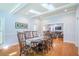 Formal dining room featuring an oval table, wood chairs, and view into living room at 772 Preservation Pl, Mount Pleasant, SC 29464