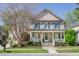 Beautiful two-story home with a cozy front porch, green shutters and mature landscaping at 772 Preservation Pl, Mount Pleasant, SC 29464