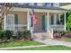 Charming front porch with American flag, green shutters, and well-maintained landscaping at 772 Preservation Pl, Mount Pleasant, SC 29464