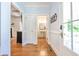 Hallway with hardwood floors, access to half bath, and decorative architectural details at 772 Preservation Pl, Mount Pleasant, SC 29464