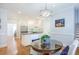 Kitchen with white cabinets, stainless steel appliances, and a round glass table with chairs at 772 Preservation Pl, Mount Pleasant, SC 29464