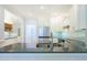 Well-lit kitchen featuring white cabinets, stainless steel appliances, granite countertops, and hardwood floors at 772 Preservation Pl, Mount Pleasant, SC 29464