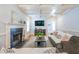 Bright living room with fireplace, coffered ceiling, modern furniture, and hardwood floors at 772 Preservation Pl, Mount Pleasant, SC 29464
