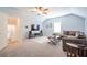 Spacious living room featuring a large sectional sofa, TV, ceiling fan and neutral color palette at 772 Preservation Pl, Mount Pleasant, SC 29464