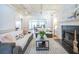 Inviting living room featuring a fireplace, large windows, and hardwood floors at 772 Preservation Pl, Mount Pleasant, SC 29464