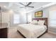 Inviting main bedroom with tray ceiling, ceiling fan, plush carpet, and plenty of natural light at 772 Preservation Pl, Mount Pleasant, SC 29464