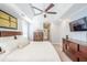 Bright main bedroom showcasing tray ceiling, carpet, and ensuite bathroom at 772 Preservation Pl, Mount Pleasant, SC 29464
