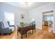 Bright office with hardwood floors, large desk, comfortable chair, and view of the kitchen at 772 Preservation Pl, Mount Pleasant, SC 29464