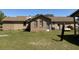 Rear exterior view of a brick home, showcasing a spacious backyard at 7819 Bells Hwy, Ruffin, SC 29475