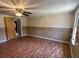 Bedroom featuring laminate floors, ceiling fan, and natural light from a window at 7819 Bells Hwy, Ruffin, SC 29475
