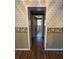 Hallway view to bathroom, showcasing neutral wall paper and flooring at 7819 Bells Hwy, Ruffin, SC 29475