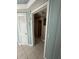 Hallway features a tiled floor, textured blue walls, and doors at 7819 Bells Hwy, Ruffin, SC 29475