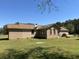 Back of a brick home with green grass, mature trees, and a satellite dish at 7819 Bells Hwy, Ruffin, SC 29475