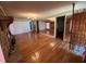 Open living room features a stone fireplace, hardwood floors, and mirrored wall for added depth at 7819 Bells Hwy, Ruffin, SC 29475