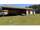 A view of the open side of an outbuilding with a car inside and a grassy yard at 7819 Bells Hwy, Ruffin, SC 29475