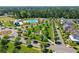 Overhead view of community amenities, including a pool and barn, surrounded by lush trees and manicured lawns at 804 Buckler St, Summerville, SC 29486