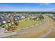Areal view of vibrant community featuring a central green space with manicured landscaping and colorful homes at 804 Buckler St, Summerville, SC 29486