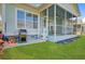 Exterior view of back porch, gas grill, stairs, and window overlooking the manicured backyard at 804 Buckler St, Summerville, SC 29486