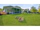 Lush backyard with garden bed, green lawn and views of the back of the house with screened-in porch at 804 Buckler St, Summerville, SC 29486