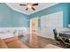 Bedroom with stylish blue walls, hardwood floors, and a large white dry erase calendar on the wall at 804 Buckler St, Summerville, SC 29486