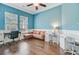 Bright bedroom with stylish blue walls, hardwood floors, and large windows providing lots of natural light at 804 Buckler St, Summerville, SC 29486