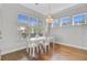 Bright breakfast nook featuring large windows, hardwood floors, and a modern chandelier at 804 Buckler St, Summerville, SC 29486