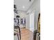 Bright walk-in closet with hardwood floors and ample storage shelving with hanging clothes for organization at 804 Buckler St, Summerville, SC 29486