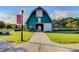 Beautifully constructed community barn with green siding, and a pristine lawn on a sunny day at 804 Buckler St, Summerville, SC 29486
