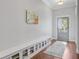 Bright entryway features hardwood floors, storage bench, and a view of the front door and American flag at 804 Buckler St, Summerville, SC 29486