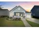 Charming single-story home featuring a welcoming front porch, manicured lawn, and a two-car attached garage at 804 Buckler St, Summerville, SC 29486
