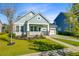 Charming single-story home featuring a welcoming front porch, manicured lawn, and a two-car attached garage at 804 Buckler St, Summerville, SC 29486