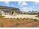 Back of the farm store with umbrellas and picnic tables on a gravel seating area at 804 Buckler St, Summerville, SC 29486