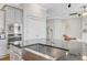 Close-up of a kitchen island with granite countertops, stainless steel sink, and stylish faucet at 804 Buckler St, Summerville, SC 29486