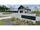 Exterior view of the Midtown Club featuring a brick sign, elegant landscaping and a well-maintained building at 820 Gentle Breeze Dr, Summerville, SC 29486