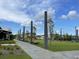 Inviting walkway through the community, featuring manicured lawn, seating and mature trees under a partly cloudy sky at 820 Gentle Breeze Dr, Summerville, SC 29486