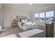 Bright main bedroom with carpet flooring features three large windows, side tables and an inviting king bed at 820 Gentle Breeze Dr, Summerville, SC 29486