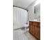 Well-lit bathroom featuring patterned floors, modern fixtures, and a stylish shower curtain at 8842 Gable St, North Charleston, SC 29406