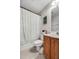 Well-lit bathroom featuring a vanity with wooden cabinets and a shower with a decorative patterned curtain at 8842 Gable St, North Charleston, SC 29406