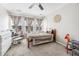 Bright ' bedroom featuring a ceiling fan, natural light, and a crib next to the comfy rocking chair at 8842 Gable St, North Charleston, SC 29406