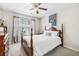 Cozy bedroom featuring a four-poster bed, neutral walls, a ceiling fan and natural light from the window at 8842 Gable St, North Charleston, SC 29406