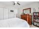 Charming bedroom with a white bed, a ceiling fan, and a dresser with a mirror and plenty of storage at 8842 Gable St, North Charleston, SC 29406