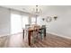 Dining room featuring hardwood floors, lots of light, a rustic wood table and an elegant chandelier at 8842 Gable St, North Charleston, SC 29406